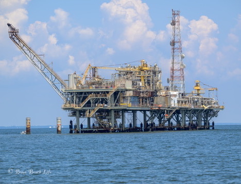 Offshore platform photographed across blue Gulf of Mexico water.