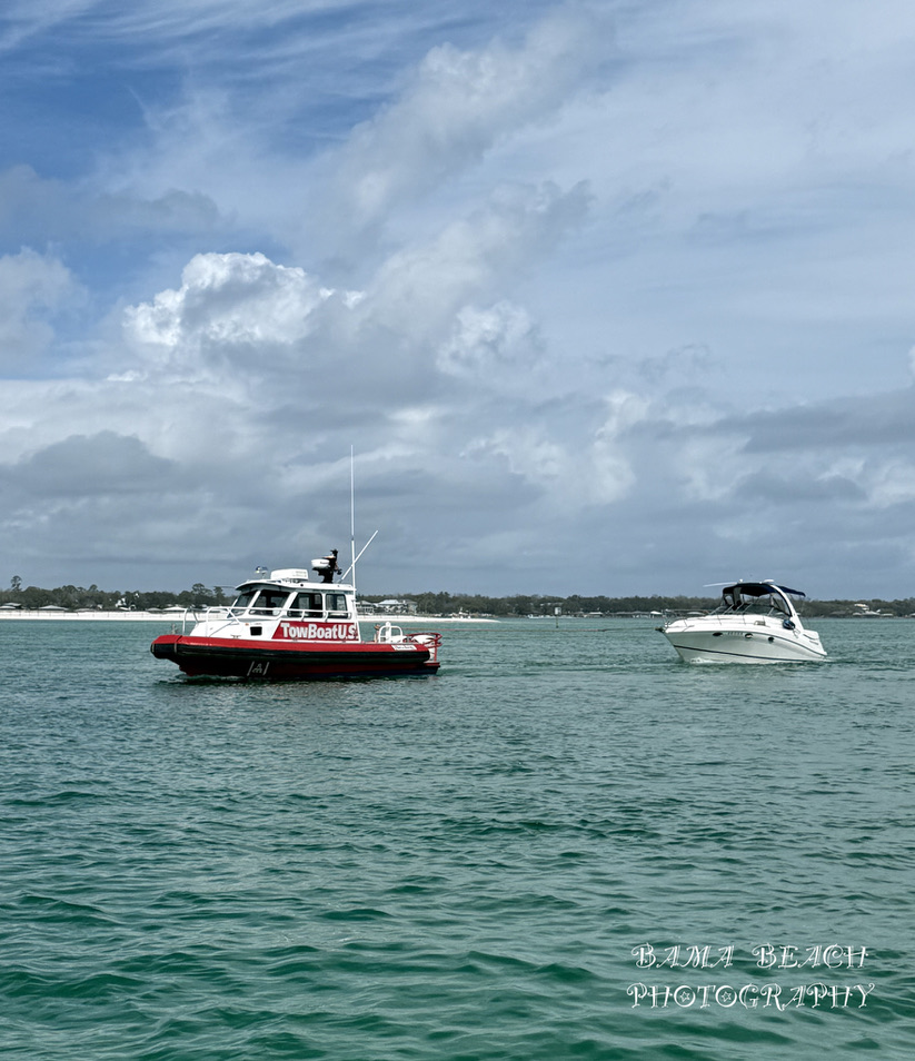TowBoatUS marine assistance vessel and recreational boat on Alabama Gulf Coast water.